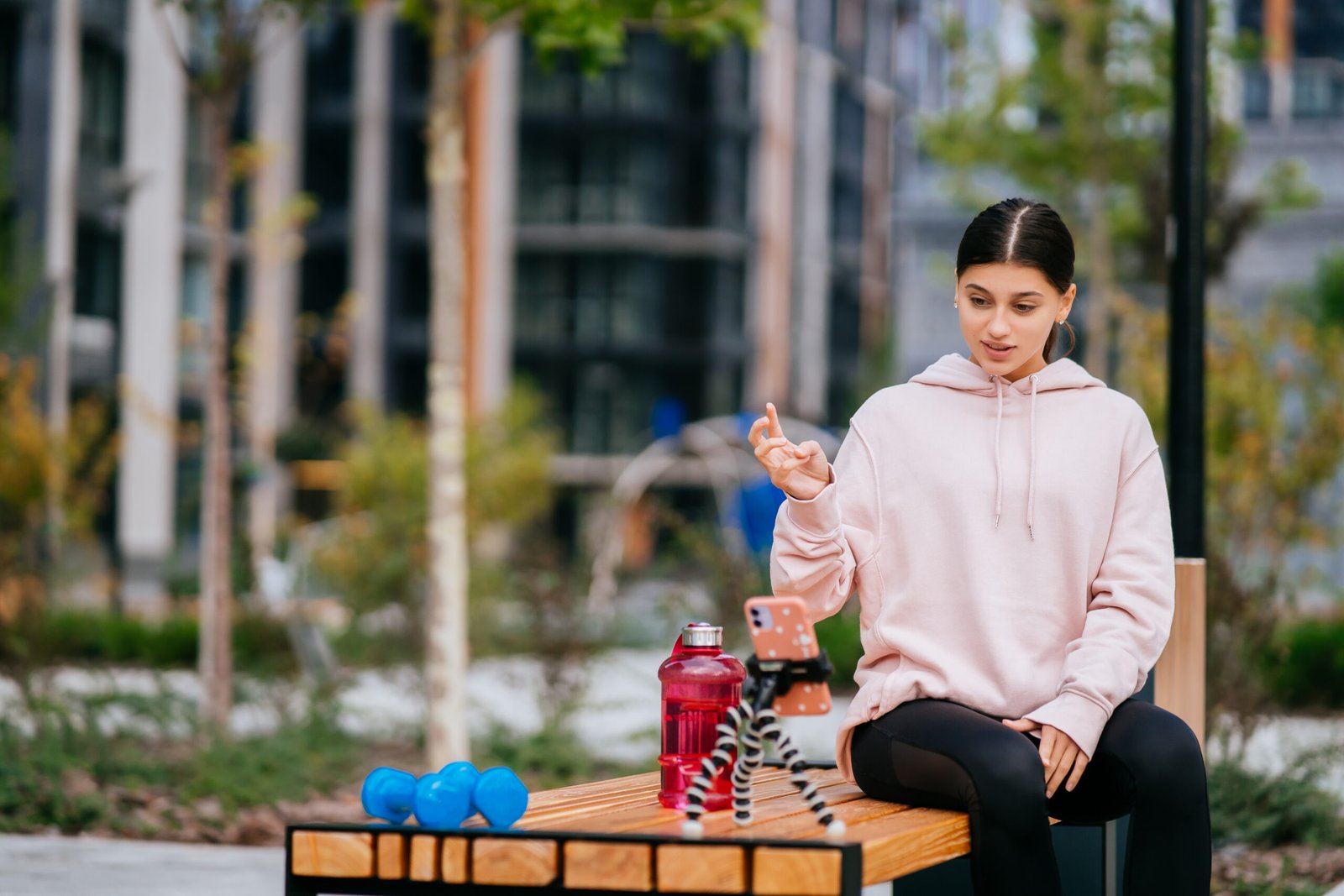 Attractive girl blogger communicates via smartphone spending time outdoors